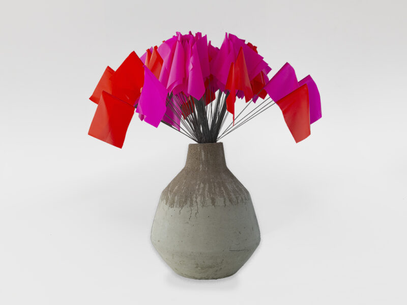 Vase #1, 2024 | concrete, organ pipe, marking flags, 73 x 32 x 32 cm